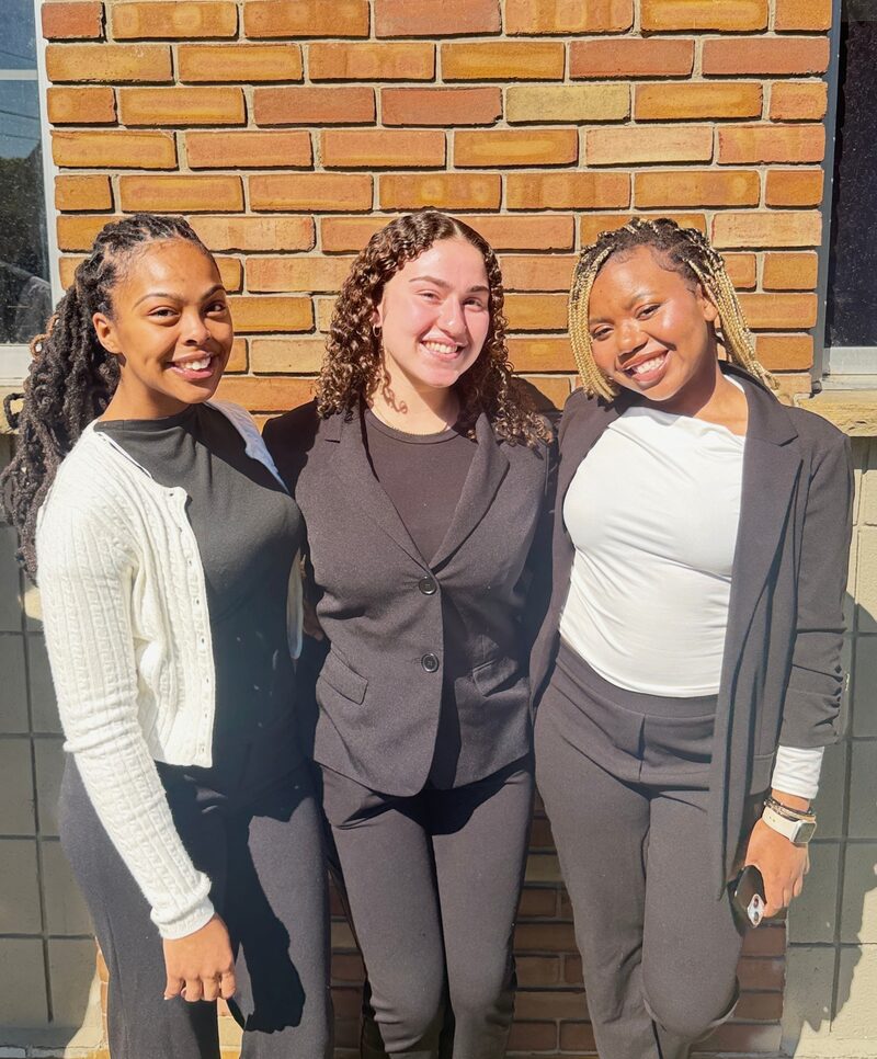 Three Raedemption Marketing team members smiling outside the North Tonawanda office
